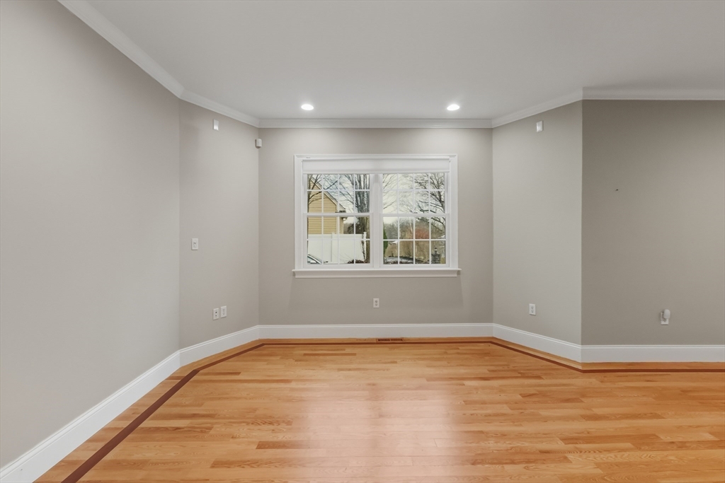 1327 Liberty Street, Unit 2 Braintree, MA 02184 - Photo 7 of 20 a view of empty room with wooden floor and fan