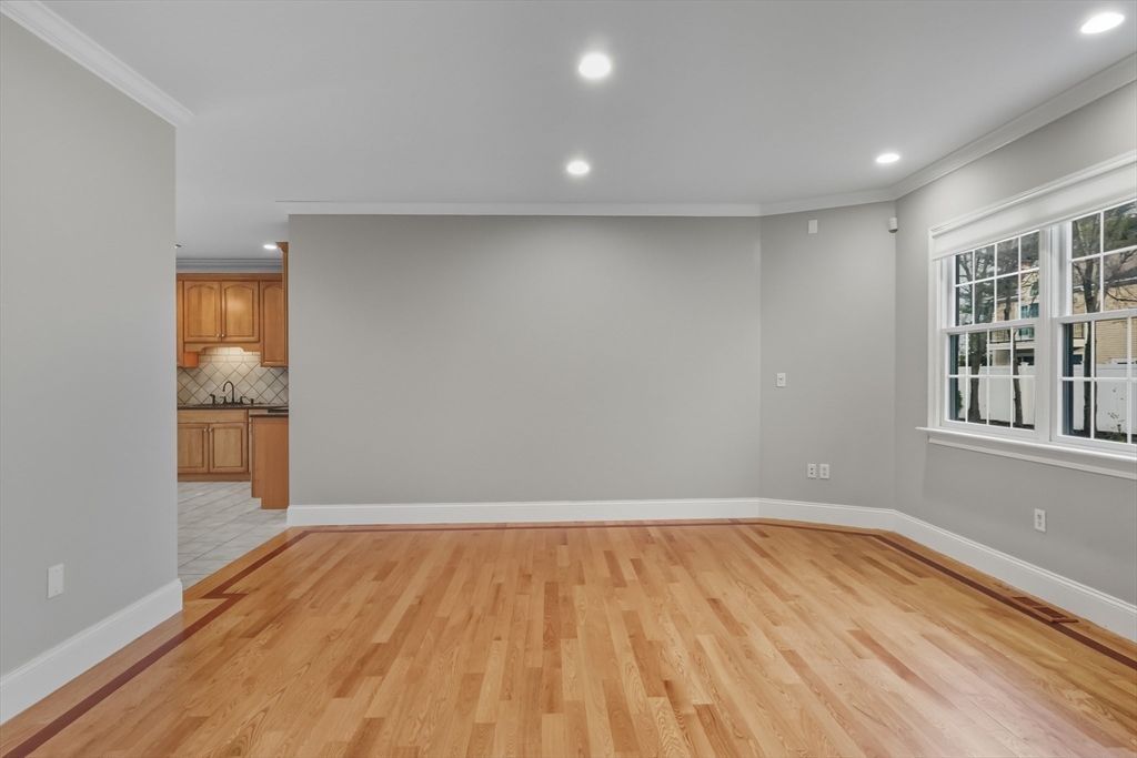 1327 Liberty Street, Unit 2 Braintree, MA 02184 - Photo 8 of 20 a view of empty room with wooden floor and fan