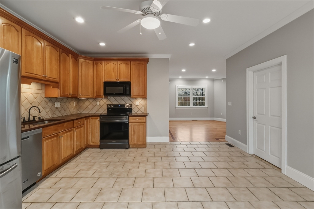 1327 Liberty Street, Unit 2 Braintree, MA 02184 - Photo 10 of 20 a kitchen with stainless steel appliances granite countertop a stove sink and cabinets
