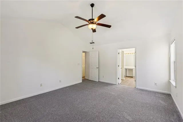 a view of empty room with ceiling fan