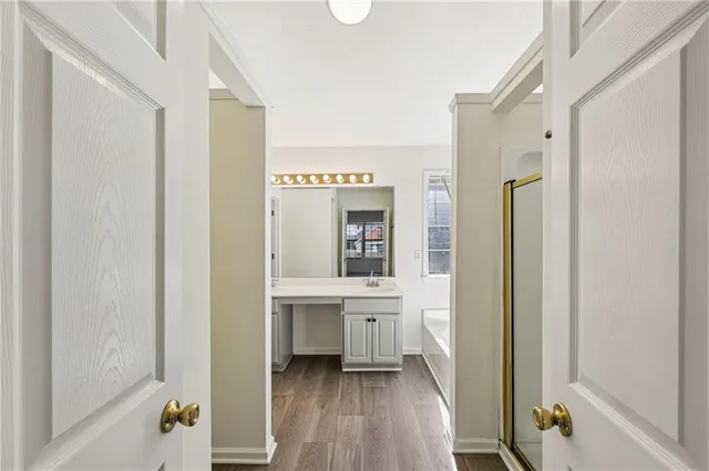 a en suite bathroom with a sink a mirror and a bathtub