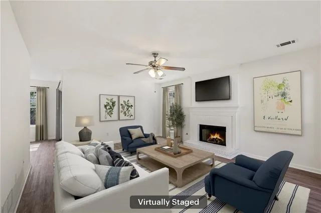 a living room with furniture a fireplace and a flat screen tv