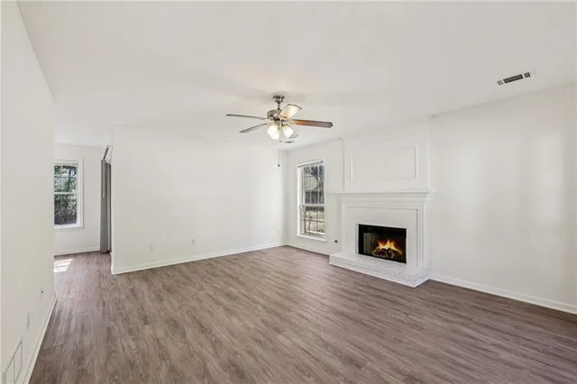 a view of main area fire place window and wooden floor