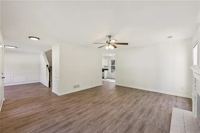 a view of a room with wooden floor