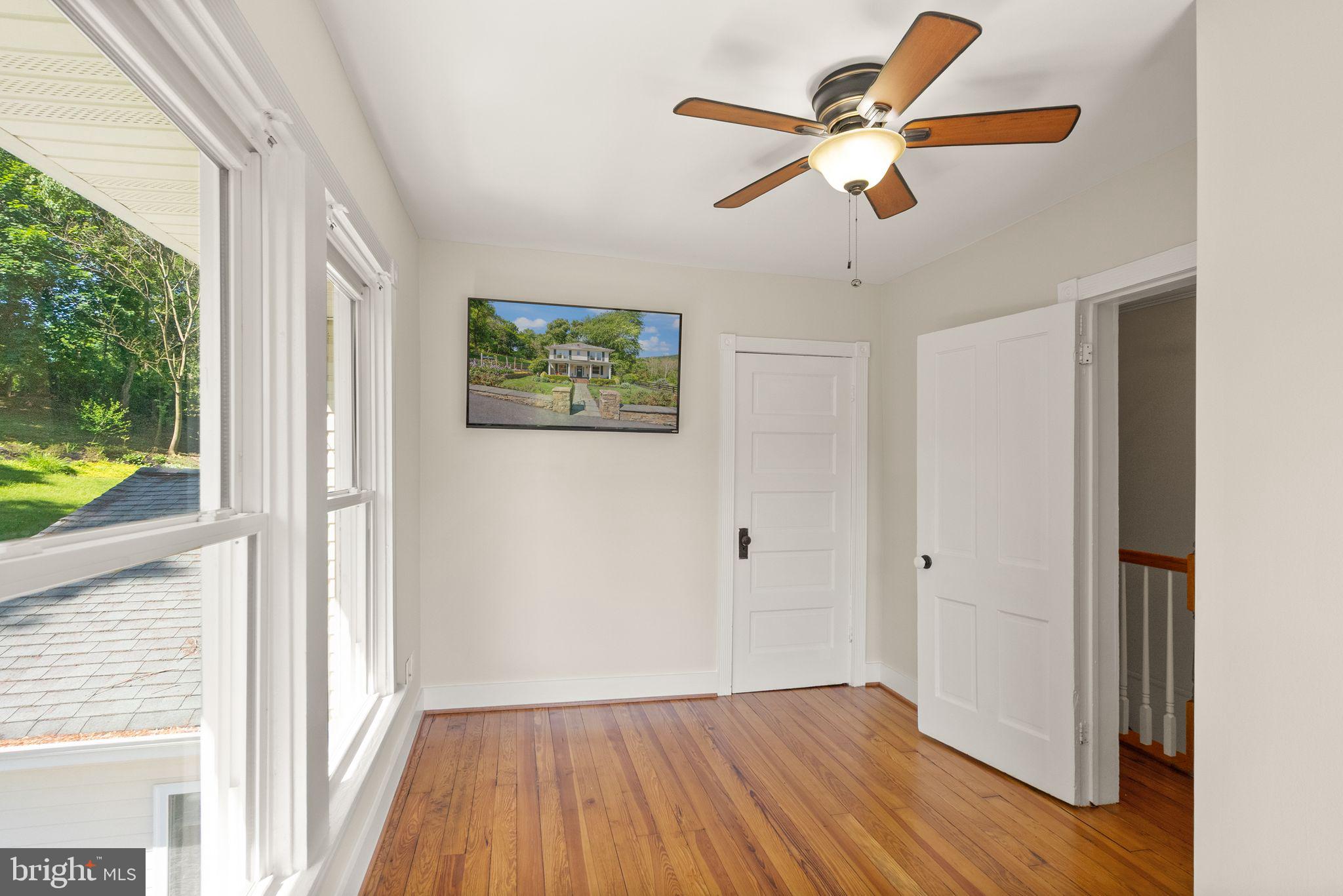 37151 Branchriver Road Purcellville, VA 20132 - Photo 41 of 63 a view of room with window ceiling fan and hardwood floor