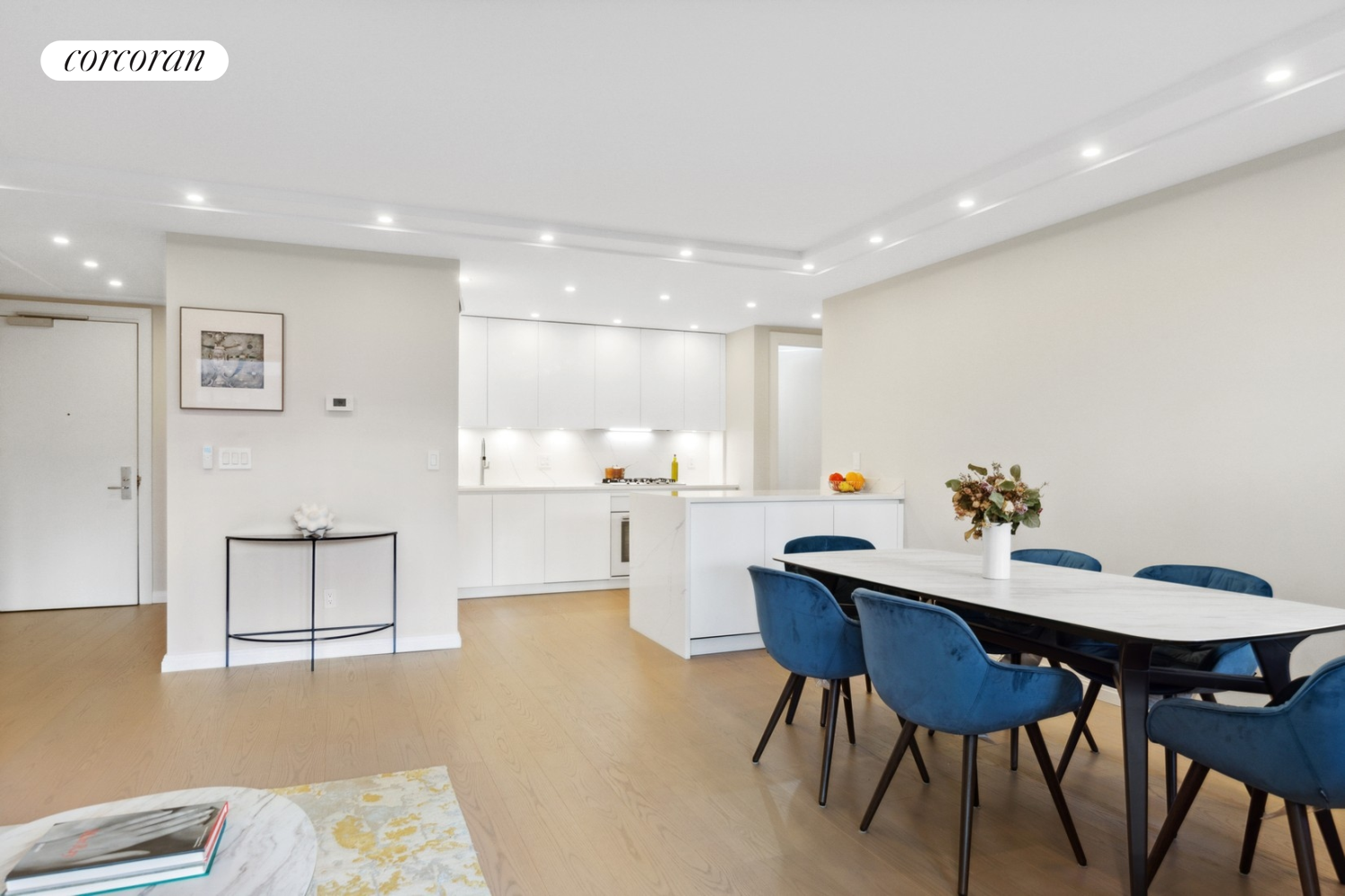 333 Rector Place, Unit 510 Manhattan, NY 10280 - Photo 3 of 10 a kitchen with a table and chairs in it