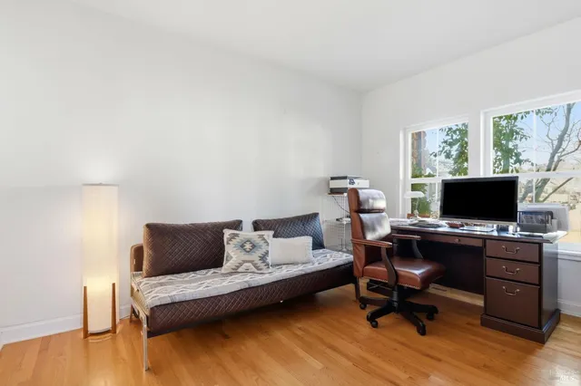 a view of a dining room with furniture and wooden floor