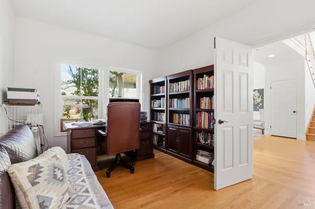 a view of hallway with furniture and a window