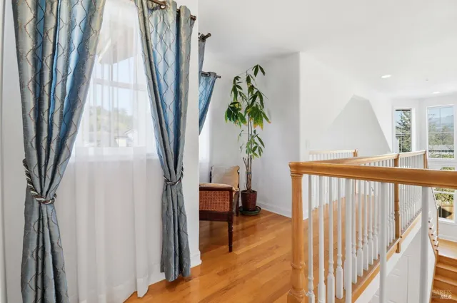 a living room with a bed furniture and a large window