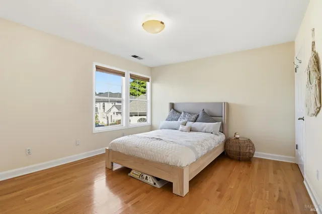 a bedroom with a bed and glass window