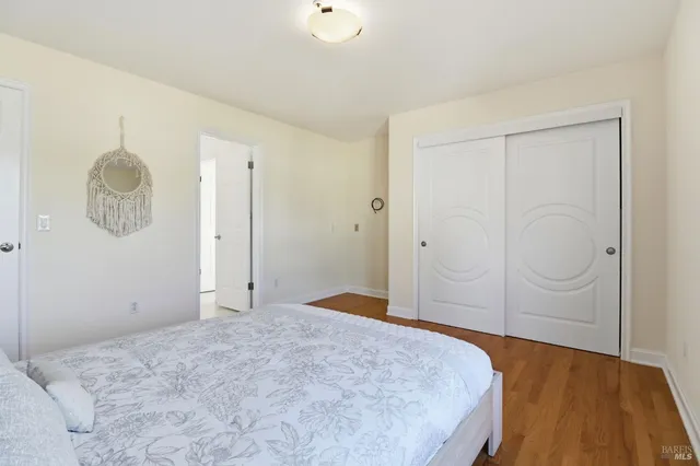 a bedroom with a bed and a refrigerator