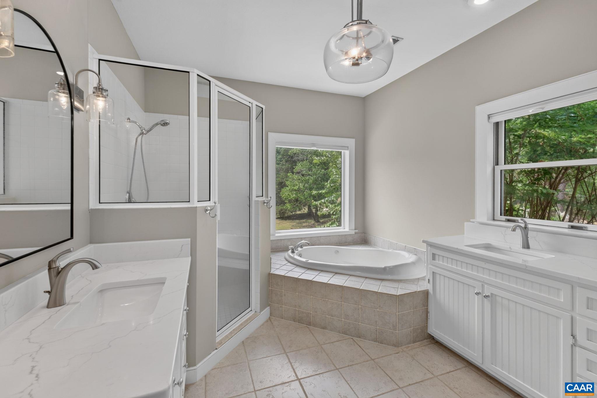 6285 Jarmans Gap Road Crozet, VA 22932 - Photo 19 of 65 a bathroom with a granite countertop sink a large mirror and a bathtub