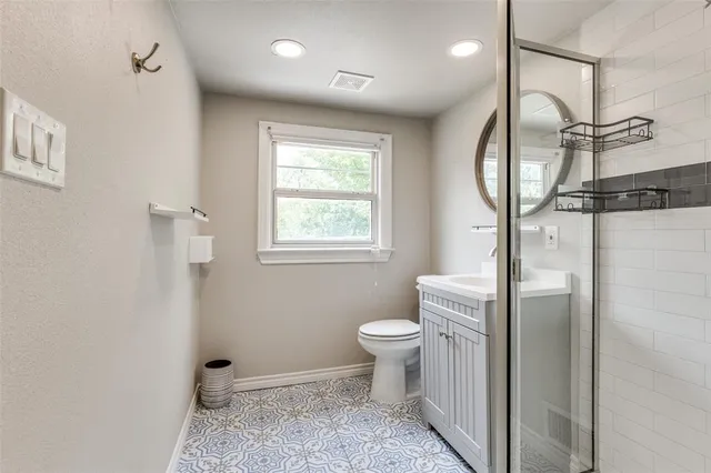 a bathroom with a toilet sink and a mirror