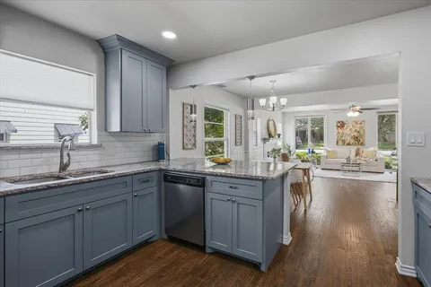 a kitchen with sink stove and cabinets