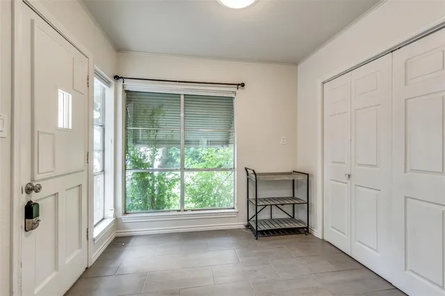 an empty room with a window and outdoor view
