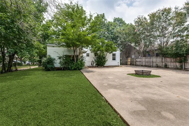 a view of a backyard with large trees