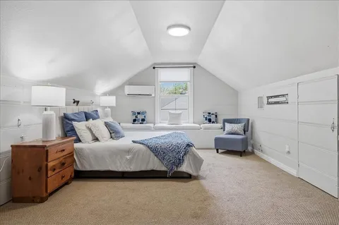 a spacious bedroom with a bed and a cabinets