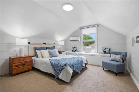 a bedroom with a bed and a couch