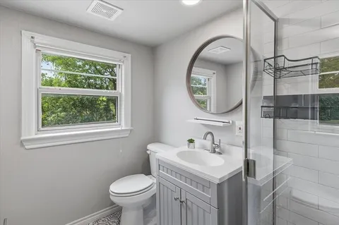 a bathroom with a toilet sink and mirror