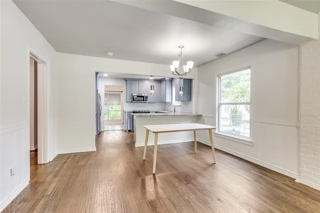 a view of kitchen with sink and wooden floor