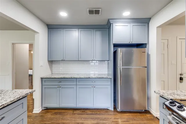 a view of a refrigerator in kitchen and a counter top space