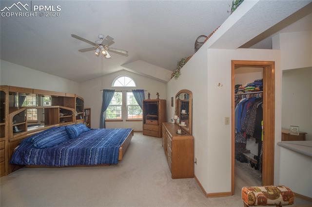 6695 Turkey Tracks Road Colorado Springs, CO 80922 - Photo 14 of 34 Master bedroom with walk-in closet
