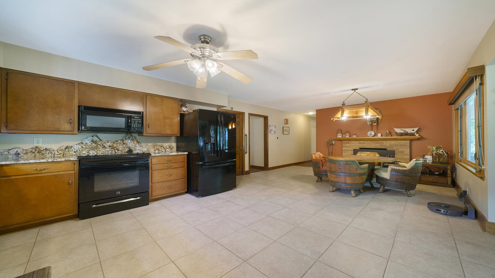310 Barbara Street Mount Morris, IL 61054 - Photo 11 of 36 a large kitchen with a stove a sink dishwasher and a refrigerator with wooden floor