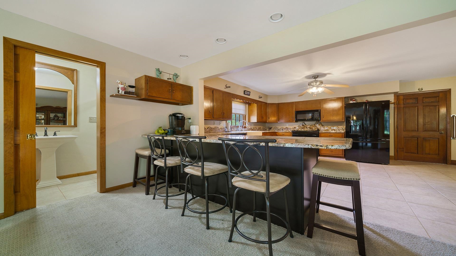 310 Barbara Street Mount Morris, IL 61054 - Photo 13 of 36 a kitchen with a dining table chairs and refrigerator