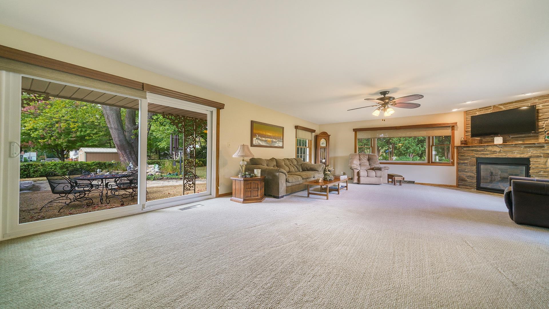 310 Barbara Street Mount Morris, IL 61054 - Photo 15 of 36 a view of a livingroom with furniture a fireplace and a large window