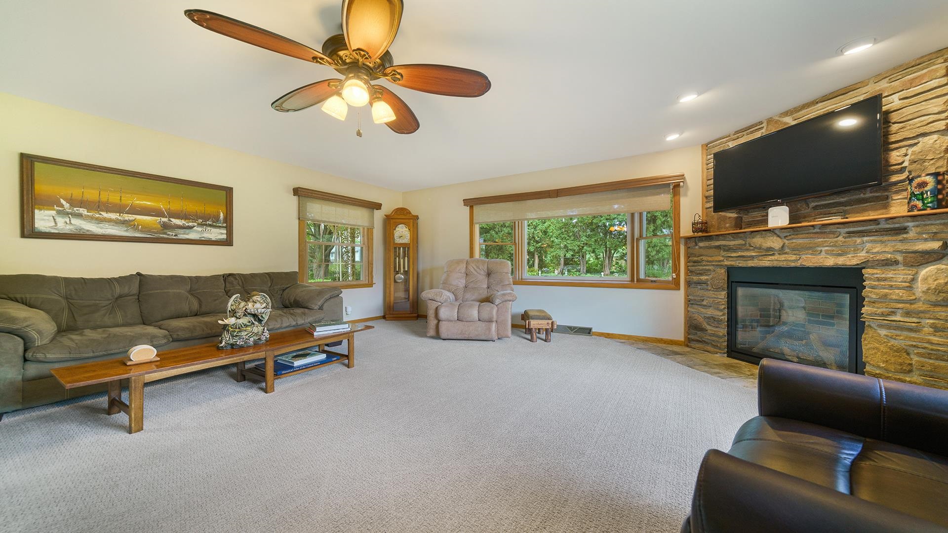 310 Barbara Street Mount Morris, IL 61054 - Photo 17 of 36 a living room with furniture flat screen tv and a fireplace