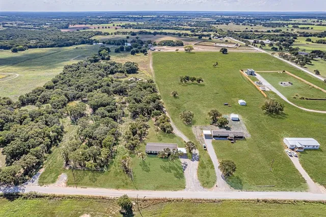 an aerial view of a residential houses with outdoor space