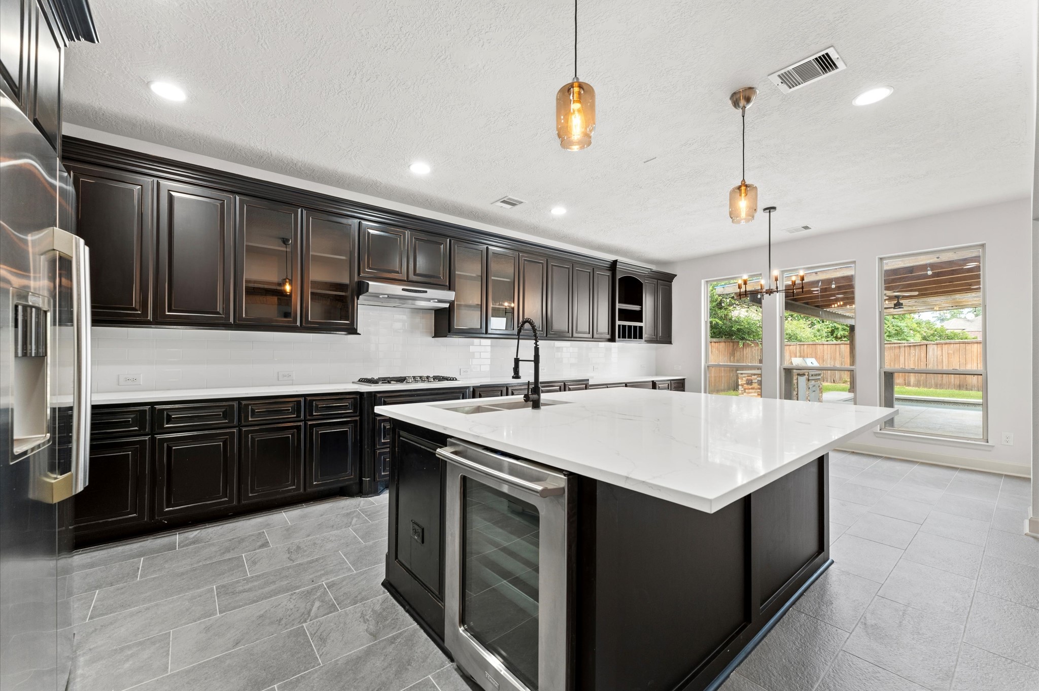 3 North Beech Springs Circle Spring, TX 77389 - Photo 12 of 43 a kitchen with kitchen island granite countertop a sink and a stove