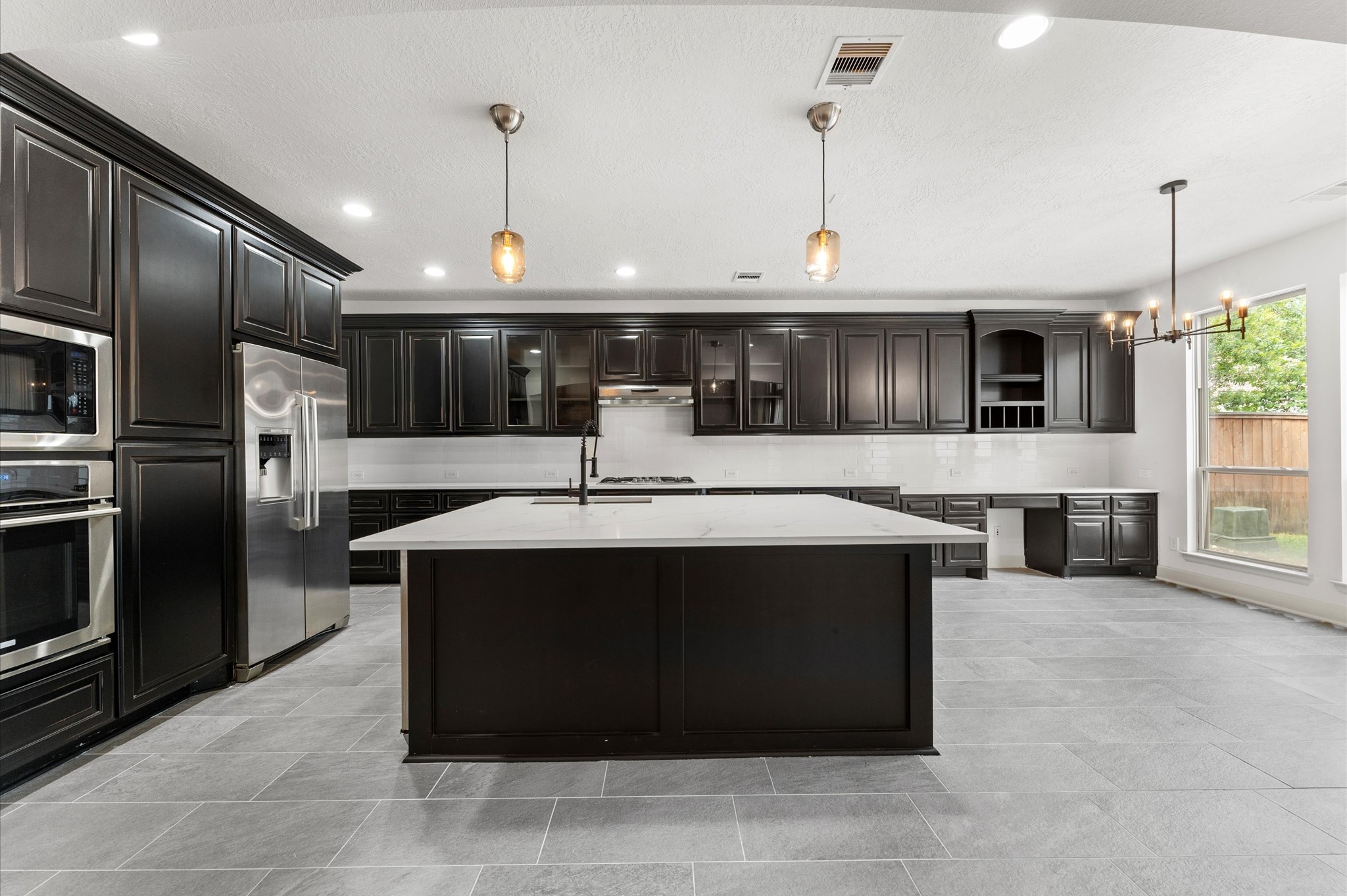 3 North Beech Springs Circle Spring, TX 77389 - Photo 13 of 43 a kitchen with a sink refrigerator and microwave
