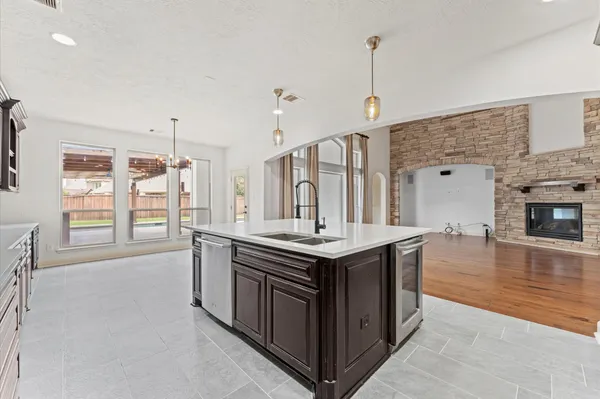 a kitchen with a stove and a wooden floor