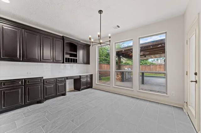 a kitchen with stainless steel appliances granite countertop a stove and cabinets