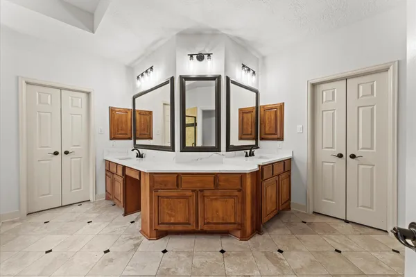 a view of a kitchen with stainless steel appliances granite countertop a stove and a refrigerator