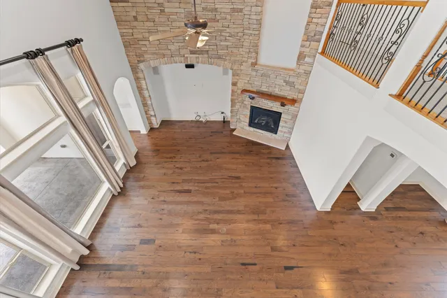 a view of a livingroom with wooden floor and staircase