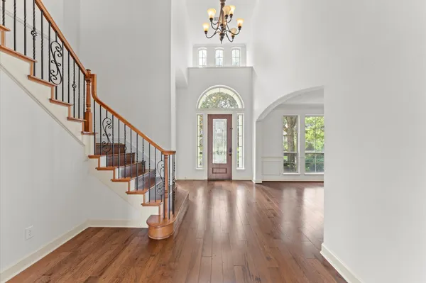 a view of entryway and hall with wooden floor