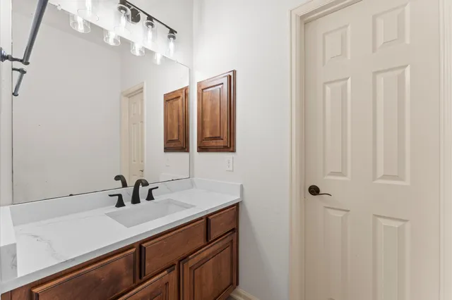 a bathroom with a sink vanity and a mirror