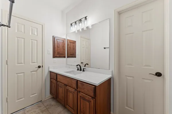 a bathroom with a double vanity sink and mirror