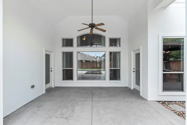 a view of a hall with windows and a fireplace
