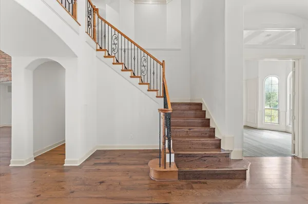 a view of entryway and hall with wooden floor