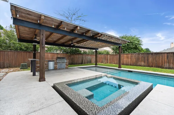 a view of a backyard with wooden fence