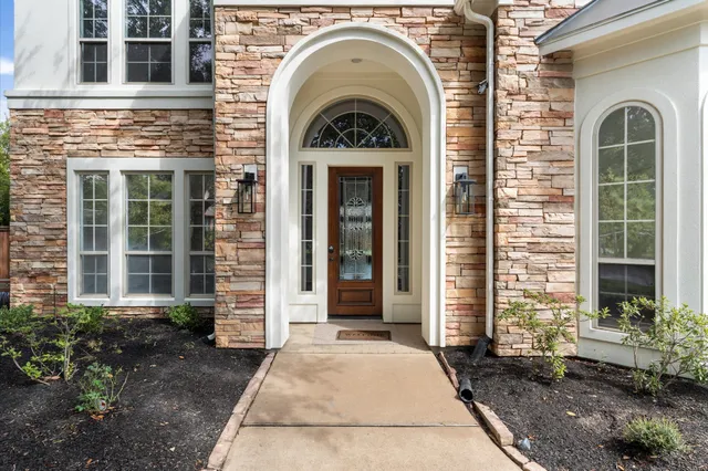 a view of a brick house with large windows