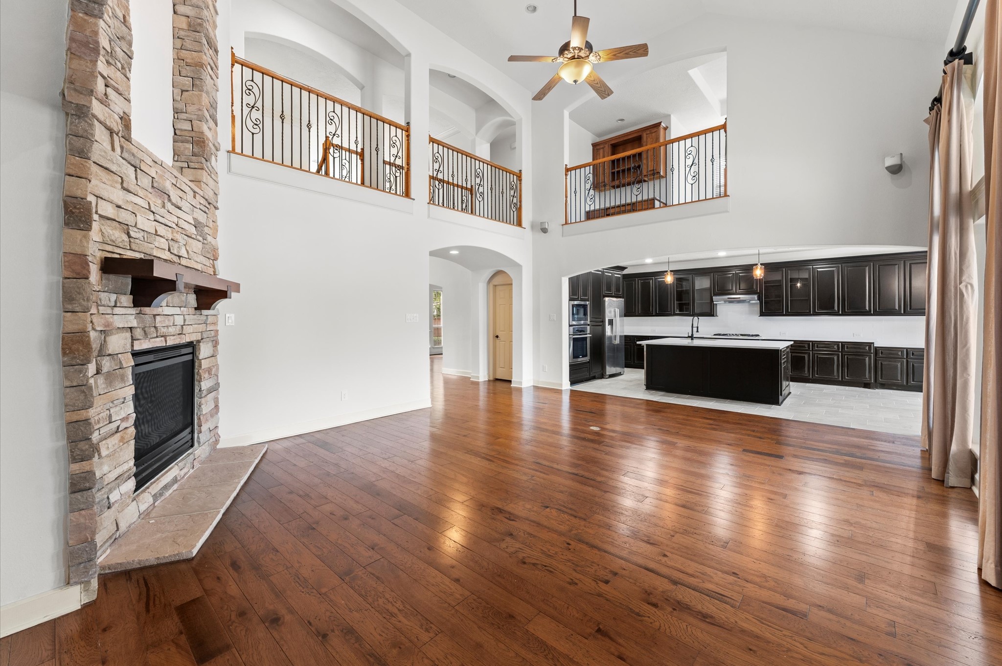 3 North Beech Springs Circle Spring, TX 77389 - Photo 7 of 43 a view of a livingroom with furniture wooden floor fireplace and windows