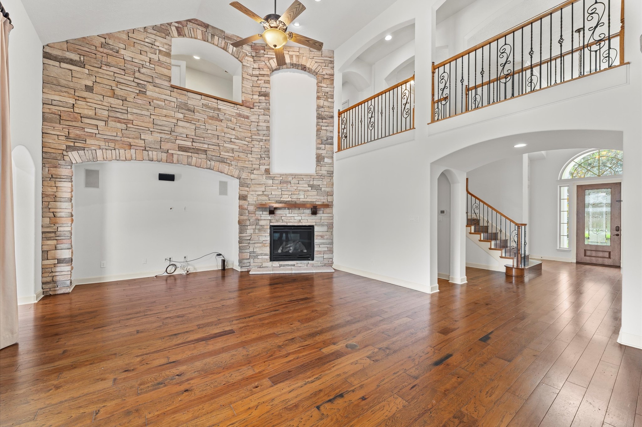 3 North Beech Springs Circle Spring, TX 77389 - Photo 8 of 43 a view of an empty room with wooden floor and a fireplace