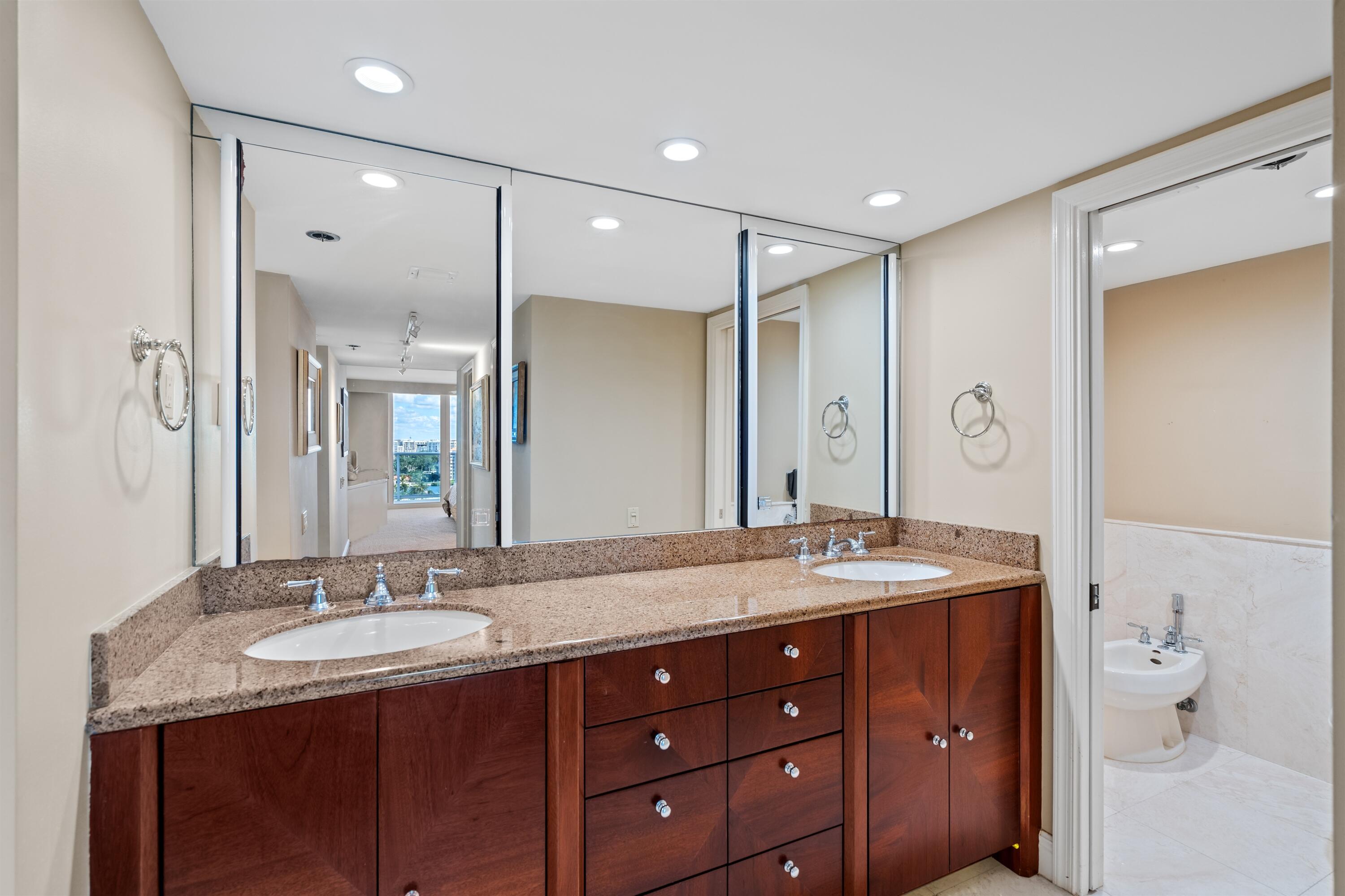 350 South Ocean Boulevard, Unit 12C Boca Raton, FL 33432 - Photo 18 of 50 a bathroom with a granite countertop shower sink double and mirror