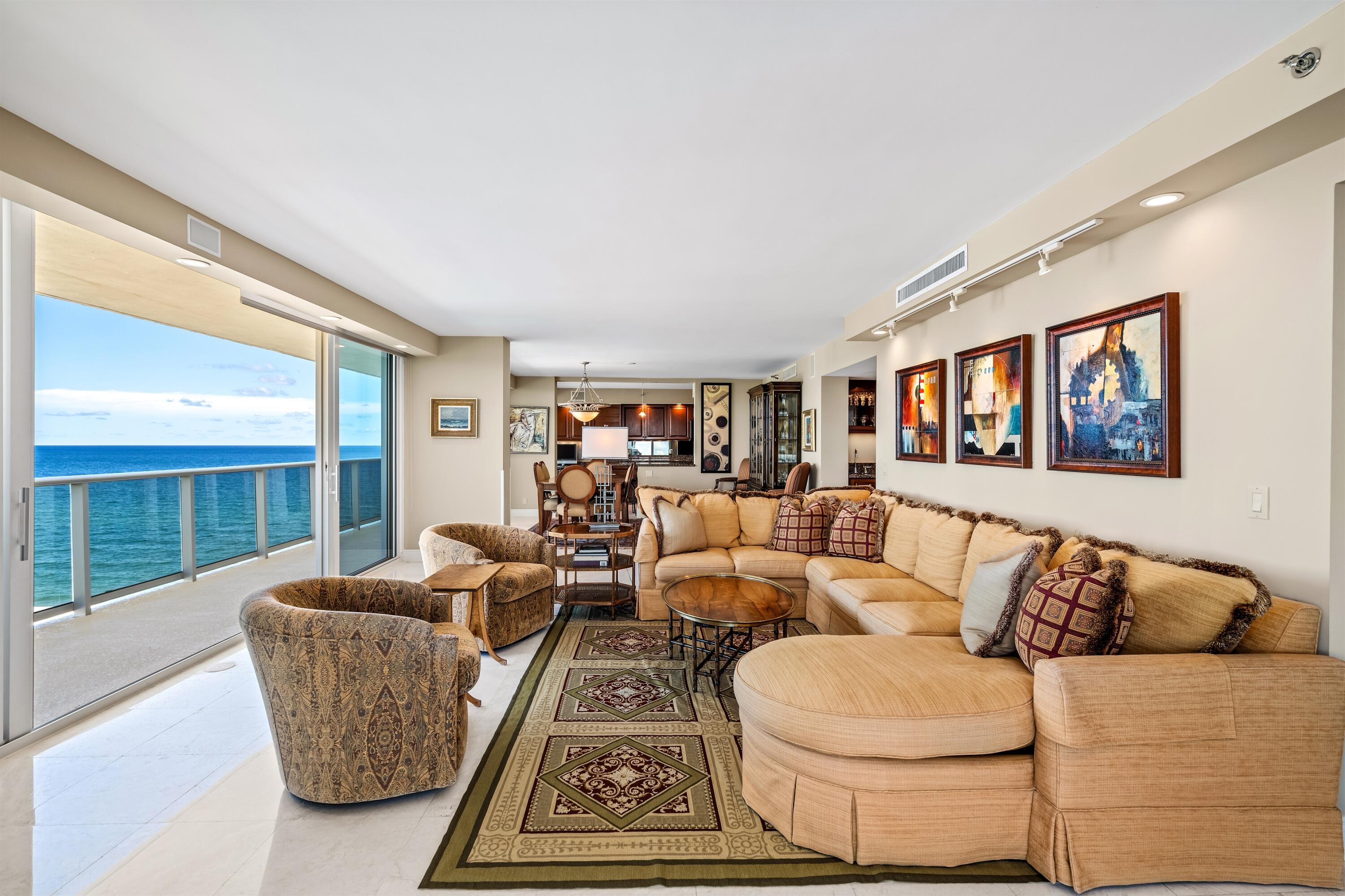 350 South Ocean Boulevard, Unit 12C Boca Raton, FL 33432 - Photo 2 of 50 a living room with furniture and a large window