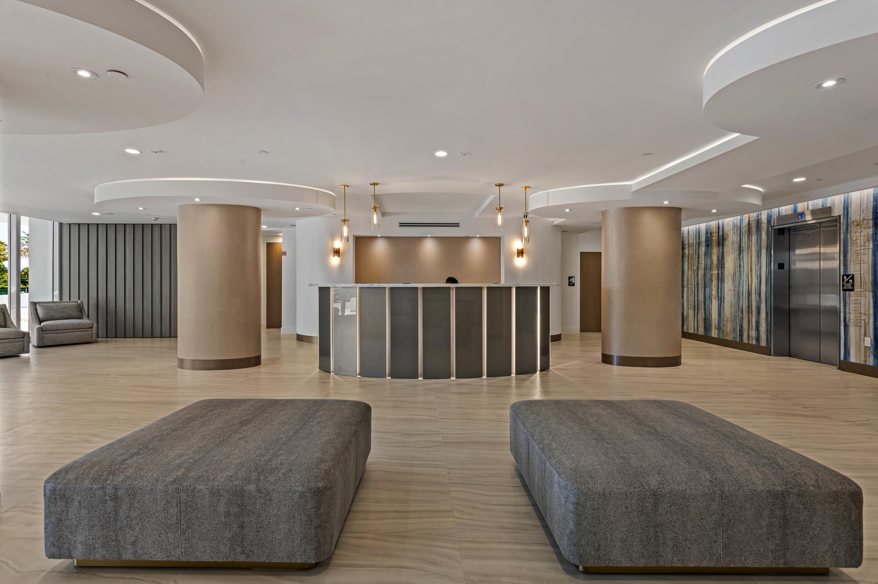 350 South Ocean Boulevard, Unit 12C Boca Raton, FL 33432 - Photo 32 of 50 a lobby with a couch and a rug