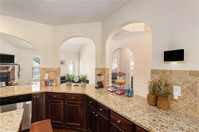 a kitchen with stainless steel appliances granite countertop a sink stove and cabinets